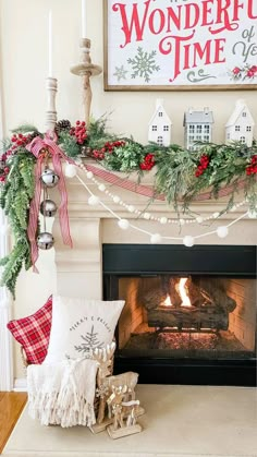 a fireplace decorated for christmas with stockings and garland