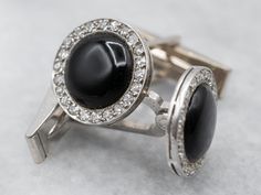 These sleek black onyx and diamond cufflinks have a perfect polish and timeless design, these vintage white gold cufflinks are in immaculate condition, and are ready to wear or give as a gift to the handsome gentleman in your life! Metal: 14K White GoldGem: 2 Black OnyxGem Measurements: 9.4 mm, RoundAccents: 44 Diamonds totaling .66 Carats, SI1 in Clarity, H in ColorMeasurements: 14 x 14 mmMarks: “14KT” Stamped on the reverse Handsome Gentleman, Diamond Cufflinks, Diamond Cufflink, Gold Statement Ring, Onyx Jewelry, Gold Cufflinks, Vintage Cufflinks, Black Onyx Ring, Diamond Anniversary