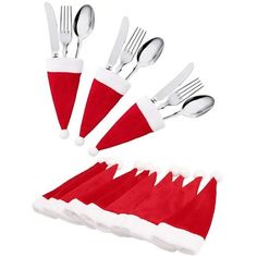 a set of forks and spoons with santa hats on them