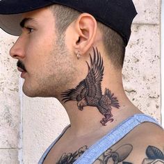 a man with a bald eagle tattoo on his neck