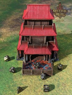 a red and brown building with dice scattered around it