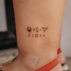 a woman's foot with three different tattoos on her legs and the word aloha written in small letters