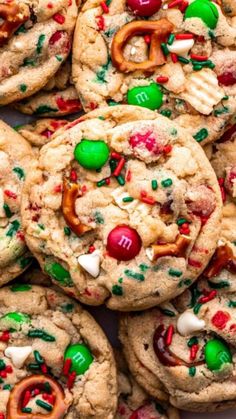 a pile of cookies with candy and pretzels on top