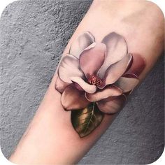 a white and pink flower on the arm