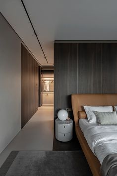 a large bed sitting next to a wooden wall