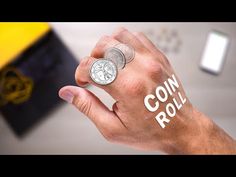 a hand holding a coin with the word coin roll written on it