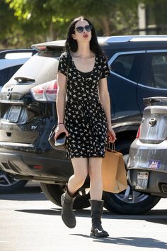 a woman walking down the street carrying shopping bags