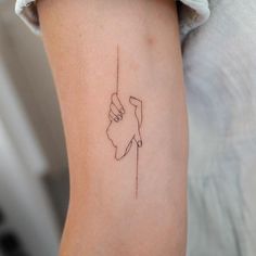 a woman's arm with a small line drawing on the left side of her arm