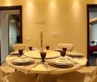 a dining room table is set with white plates and place settings