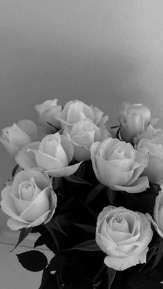 black and white photograph of roses in a vase