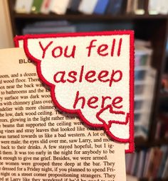 a close up of a book with a piece of paper attached to it that says, you fell asleep here