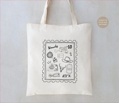 a tote bag with stamps on it and the words goodbye written in black ink