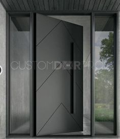 an entrance to a modern building with glass doors and metal handles on the door, in front of a concrete wall