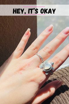 a woman's hand with a ring on it that says hey, it's okay