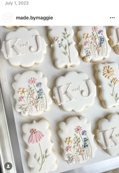 decorated cookies with the letters k and j are displayed on a cookie sheet that says made by mymagicle