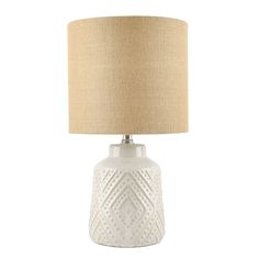 a white table lamp with a beige shade