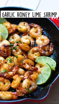 a skillet filled with shrimp and lime slices