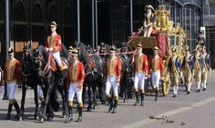 a group of men riding on the backs of horses in uniforms with gold and red accents