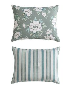 two pillows with flowers on them, one in blue and the other in green stripes