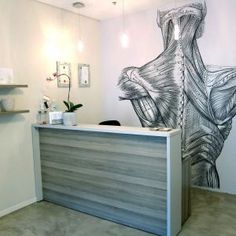 the front desk of a dental office with a large mural on the wall behind it