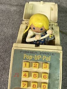 an old toy machine with a girl in it's lap and numbers on the front