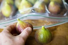 a hand is picking up an unripe figurine from a plastic bag