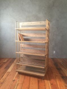 a stack of wooden shelves sitting on top of a hard wood floor