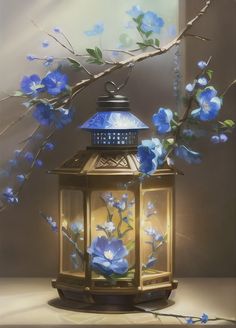 a lantern with blue flowers on it next to a branch