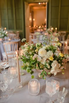 a table with candles and flowers on it