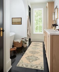 a bathroom with a large rug on the floor