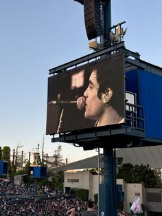 a large billboard with a man singing on it