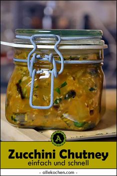 a glass jar filled with food sitting on top of a wooden table