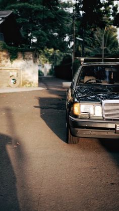 a black car parked on the side of a road