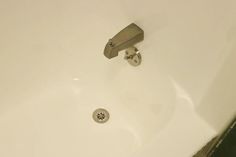 a close up of a faucet on the side of a bathtub