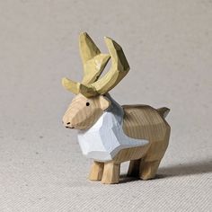 a small wooden animal with horns on it's head