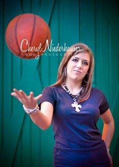 a woman holding a basketball in her right hand