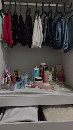 an organized closet with clothes and makeup