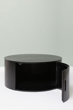 a black coffee table sitting on top of a white floor