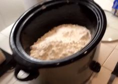 a crock pot filled with food sitting on top of a counter