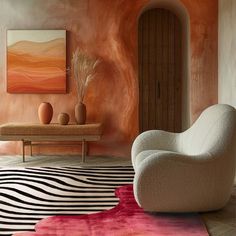 a living room with an orange and pink color scheme on the walls, rugs and furniture