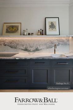 an advertisement for farrow & ball featuring marble counter tops and dark blue cabinetry