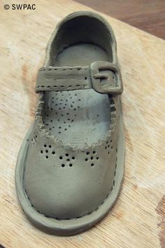 a pair of shoes sitting on top of a wooden table