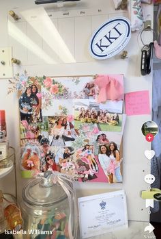 a wall with pictures and magnets on it next to a jar full of candies