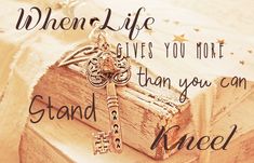 an open book with a key on it and the words when life gives you more than you can stand kneel