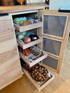 an open cabinet filled with lots of food and vegetables on top of wooden flooring