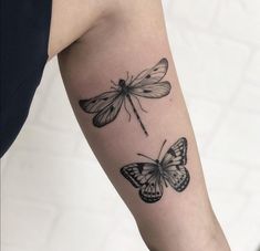 a woman's arm with two butterflies on it