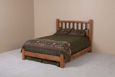 a bed sitting in the corner of a room with a wooden frame and headboard