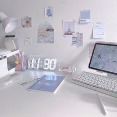 a laptop computer sitting on top of a white desk