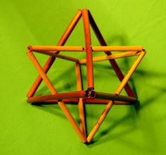 an origami star on a green background