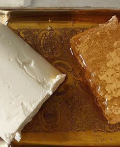 two pieces of cake sitting on top of a brown tray next to each other,